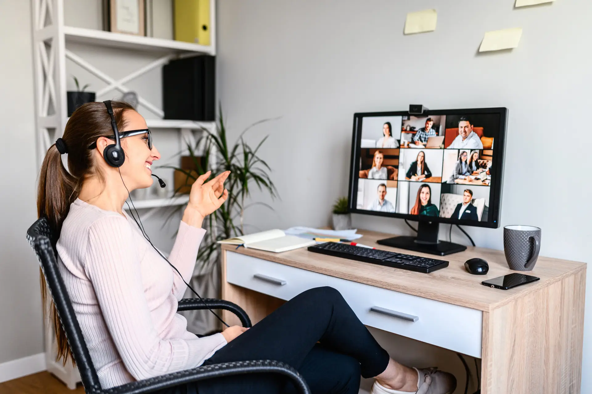 Woman with a headset having a virtual meeting