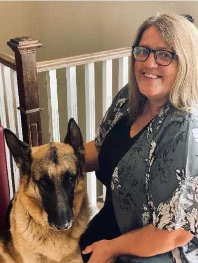 A photo of Charmaine Chisholm on the right and her german shepherd on the left